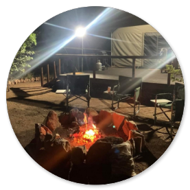 Relaxing around the fire in private boma